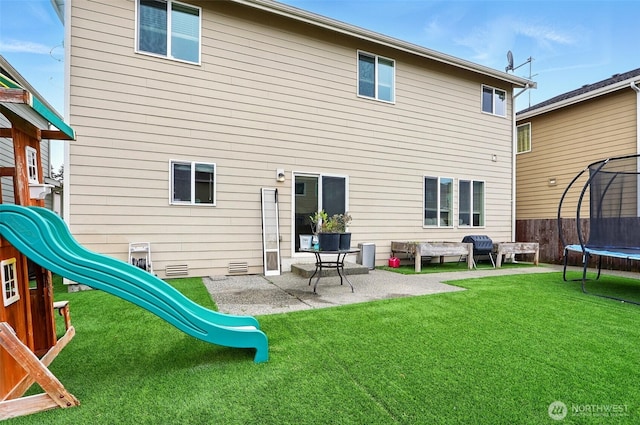 2514 164th St E, Tacoma, WA 98445 - back of house with a trampoline, a playground, and a patio area