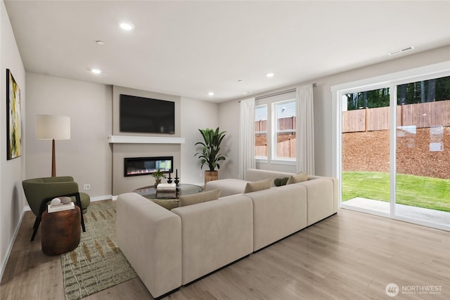9825 38th Street Ct E Unit 38, Edgewood, WA 98371 - living area featuring wood finished floors, recessed lighting, and a glass covered fireplace