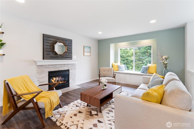 living room featuring a fireplace, wood finished floors, recessed lighting, and baseboards