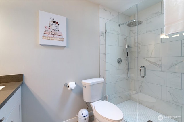 full bathroom featuring a shower stall, vanity, and toilet