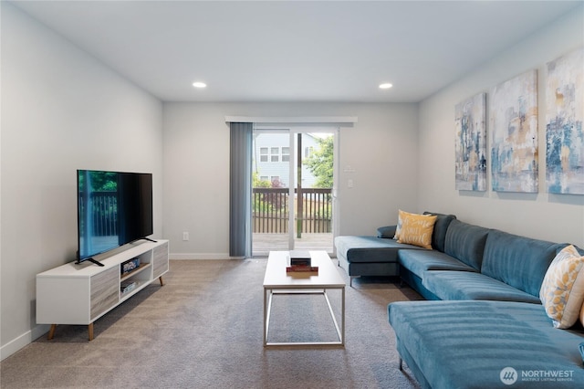 carpeted living area featuring baseboards and recessed lighting