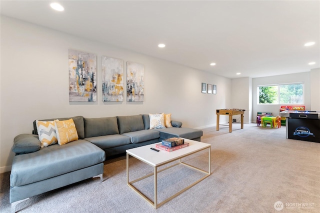 living area with recessed lighting, light colored carpet, and baseboards