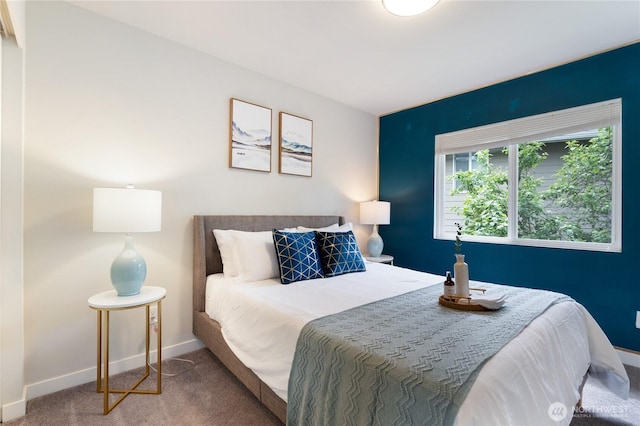 bedroom featuring carpet and baseboards