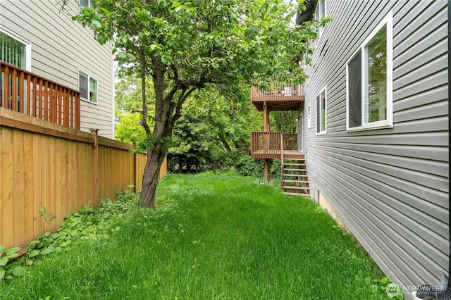 view of yard featuring stairs and a deck