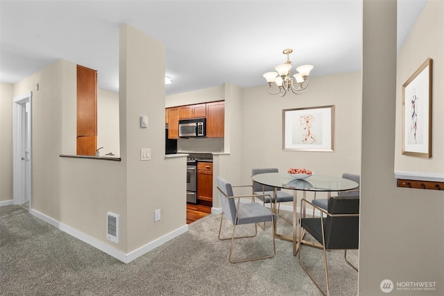 12303 Harbour Pointe Blvd Unit U109, Mukilteo, WA 98275 - dining area featuring carpet floors, baseboards, and a chandelier