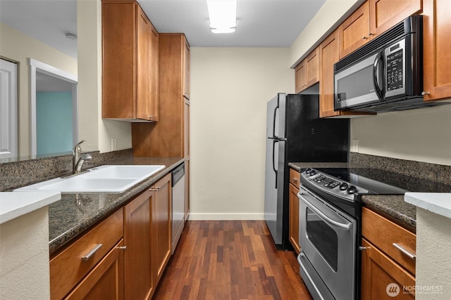 12303 Harbour Pointe Blvd Unit U109, Mukilteo, WA 98275 - kitchen featuring appliances with stainless steel finishes, a sink, dark wood finished floors, and brown cabinetry