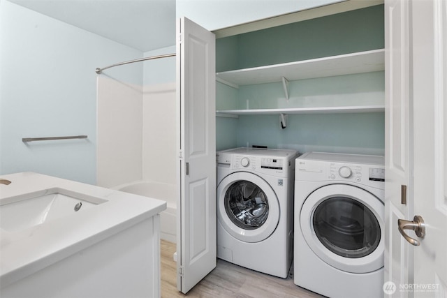 12303 Harbour Pointe Blvd Unit U109, Mukilteo, WA 98275 - laundry area with light wood-type flooring, independent washer and dryer, and a sink