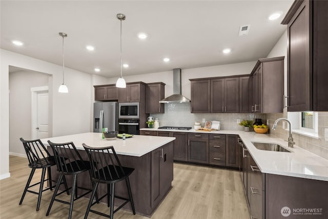 3801 98th Avenue Ct E Unit 36, Edgewood, WA 98371 - kitchen with wall chimney exhaust hood, appliances with stainless steel finishes, light wood-type flooring, dark brown cabinetry, and recessed lighting