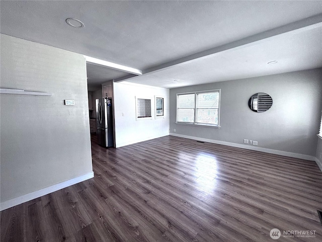 711 Guernsey St, Prosser, WA 99350 - unfurnished living room featuring dark wood-type flooring and baseboards