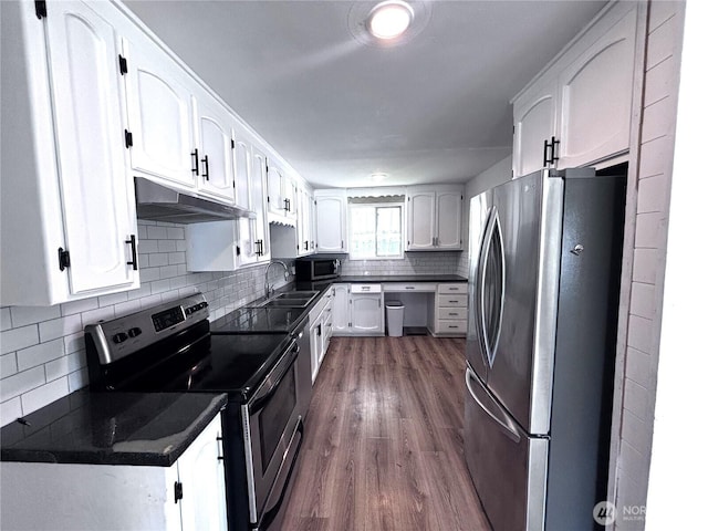 711 Guernsey St, Prosser, WA 99350 - kitchen featuring appliances with stainless steel finishes, under cabinet range hood, a sink, and dark countertops