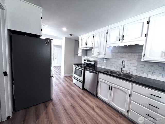 711 Guernsey St, Prosser, WA 99350 - kitchen featuring stainless steel appliances, a sink, white cabinets, dark countertops, and recessed lighting