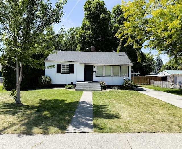 711 Guernsey St, Prosser, WA 99350 - view of front of home with concrete driveway, a chimney, board and batten siding, and roof with shingles
