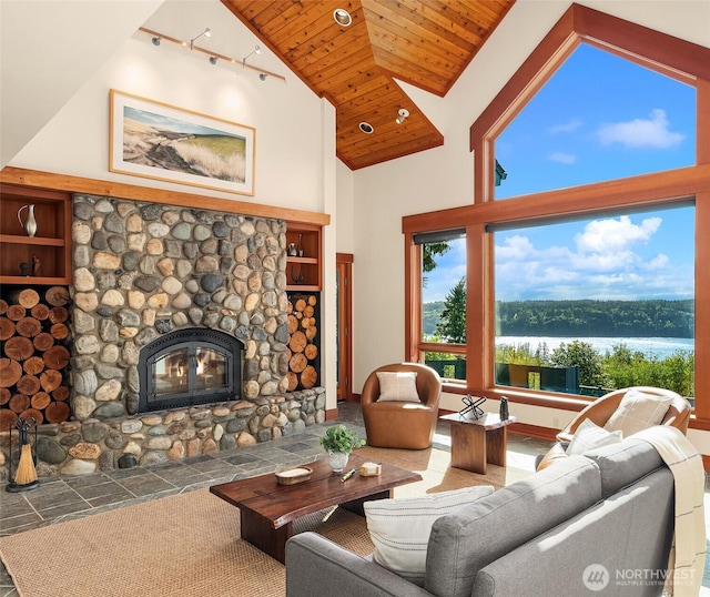 18005 Thorsen Rd SW, Vashon, WA 98070 - living room featuring wooden ceiling, a stone fireplace, a water view, high vaulted ceiling, and rail lighting