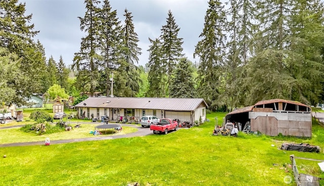 35904 Allen Rd S, Roy, WA 98580 - back of house featuring a yard, an outdoor structure, and a detached garage