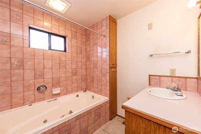 full bathroom with tiled shower / bath combo and vanity