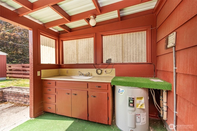 interior space featuring water heater and a sink