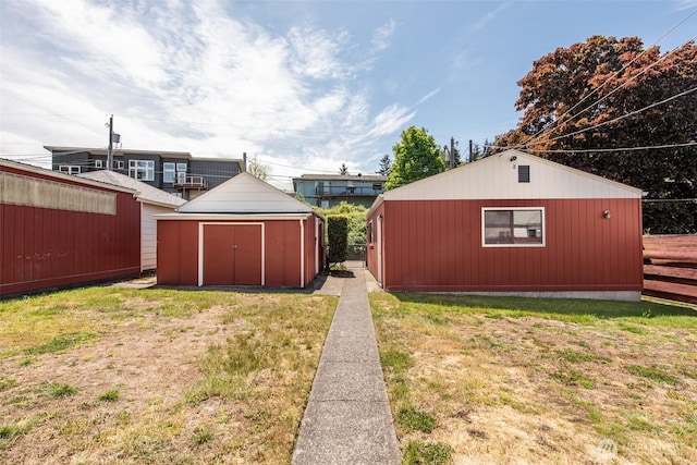 view of green lawn with a storage shed and an outdoor structure