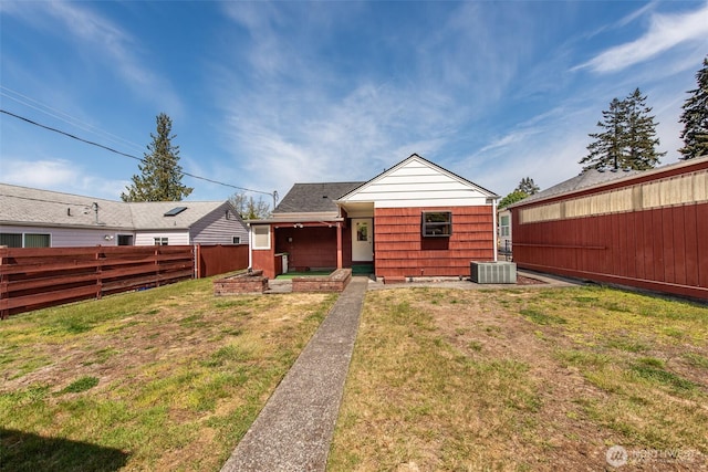 rear view of property with central AC unit