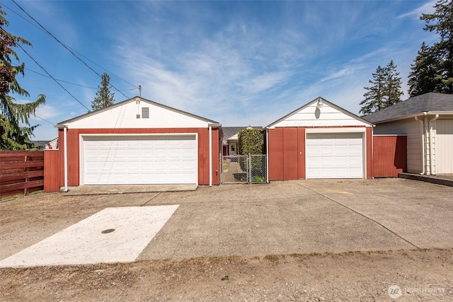detached garage featuring fence