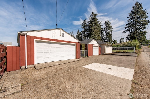 detached garage featuring fence