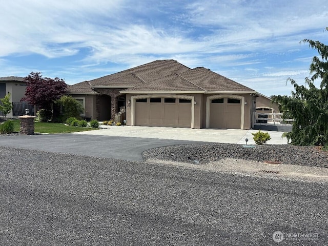 2702 N Levi St, Kennewick, WA 99338 - view of front of home with a garage, asphalt driveway, and stucco siding