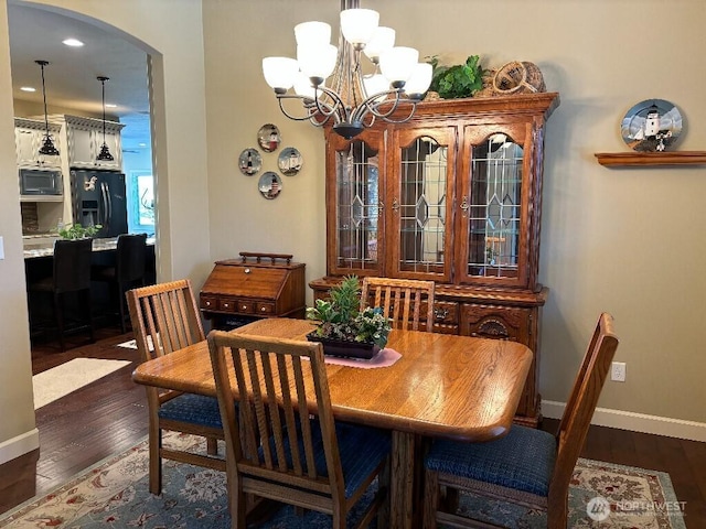 2702 N Levi St, Kennewick, WA 99338 - dining space featuring arched walkways, wood finished floors, baseboards, and a chandelier