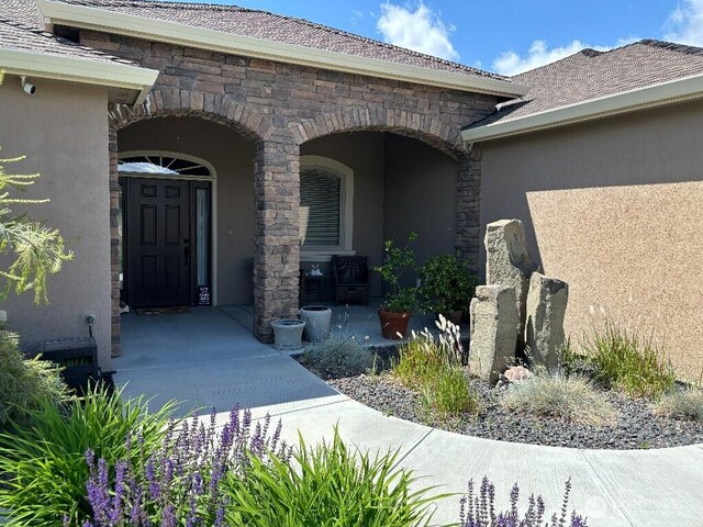 2702 N Levi St, Kennewick, WA 99338 - doorway to property with stucco siding, stone siding, and a porch