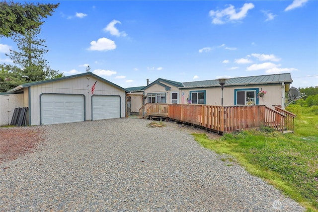 30425 6th Ave S, Roy, WA 98580 - view of front facade featuring a deck, an outdoor structure, metal roof, and gravel driveway