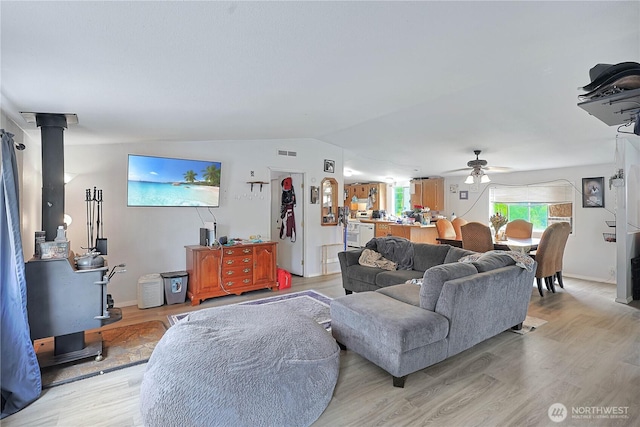30425 6th Ave S, Roy, WA 98580 - living room featuring a ceiling fan, vaulted ceiling, and light wood-style flooring