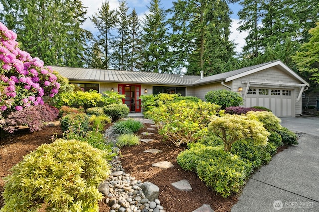 12211 SE 65th Pl, Bellevue, WA 98006 - single story home featuring a garage, concrete driveway, and metal roof