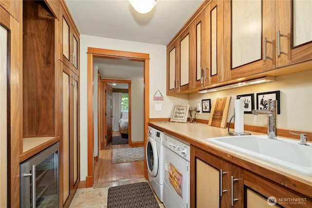 12211 SE 65th Pl, Bellevue, WA 98006 - washroom with beverage cooler, separate washer and dryer, cabinet space, and baseboards