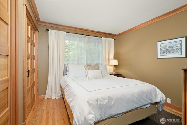12211 SE 65th Pl, Bellevue, WA 98006 - bedroom with crown molding, light wood-type flooring, and baseboards