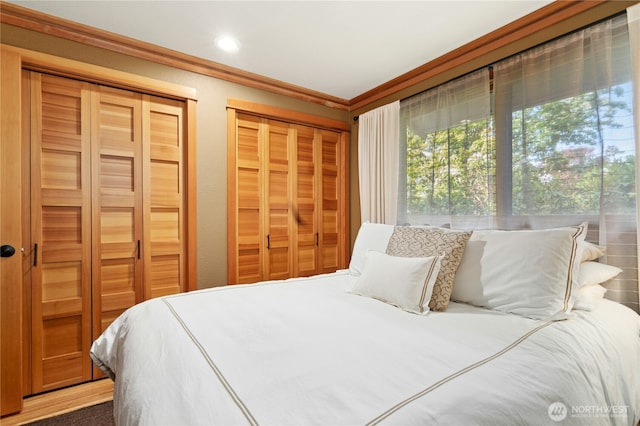 12211 SE 65th Pl, Bellevue, WA 98006 - bedroom featuring two closets, crown molding, and recessed lighting