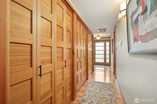12211 SE 65th Pl, Bellevue, WA 98006 - hallway featuring a textured wall, light wood-style floors, a sauna / steam room, and baseboards