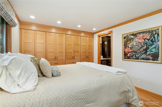 12211 SE 65th Pl, Bellevue, WA 98006 - bedroom featuring wood finished floors, recessed lighting, baseboards, and connected bathroom