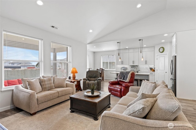 227 N Crestview Dr, Moses Lake, WA 98837 - living room with light wood-style floors, lofted ceiling, recessed lighting, and baseboards