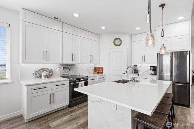 227 N Crestview Dr, Moses Lake, WA 98837 - kitchen featuring stainless steel appliances, a sink, backsplash, wood finished floors, and recessed lighting