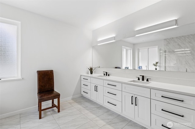 227 N Crestview Dr, Moses Lake, WA 98837 - full bath with baseboards, double vanity, marble look tile flooring, and healthy amount of natural light