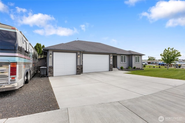 227 N Crestview Dr, Moses Lake, WA 98837 - view of front of home featuring a garage, a front lawn, concrete driveway, and stone siding