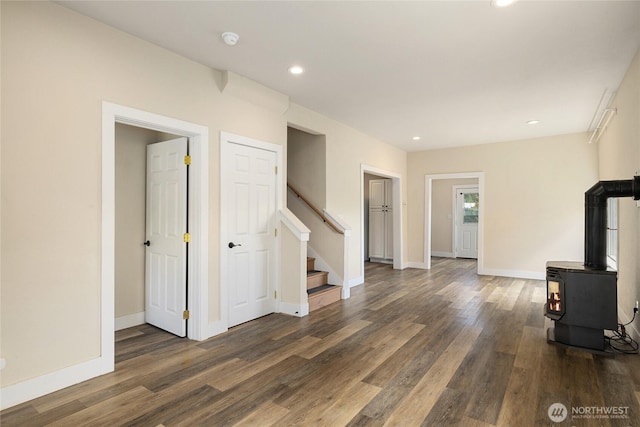 511 S 2nd St, Roslyn, WA 98941 - unfurnished living room with wood finished floors, stairway, recessed lighting, baseboards, and a wood stove