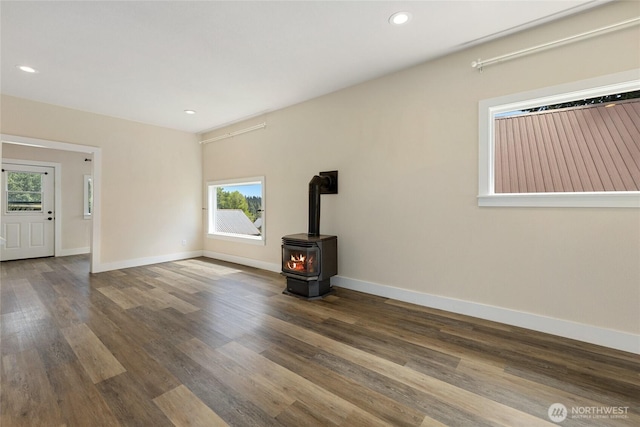 511 S 2nd St, Roslyn, WA 98941 - unfurnished living room featuring a wood stove, baseboards, wood finished floors, and recessed lighting