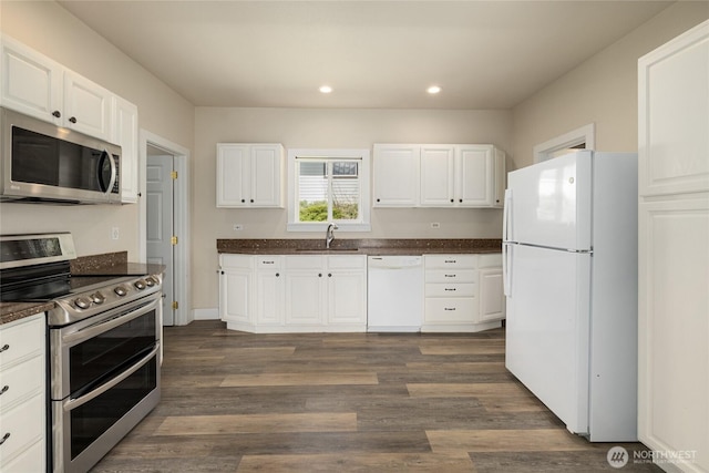 511 S 2nd St, Roslyn, WA 98941 - kitchen featuring appliances with stainless steel finishes, recessed lighting, a sink, dark wood-type flooring, and white cabinetry