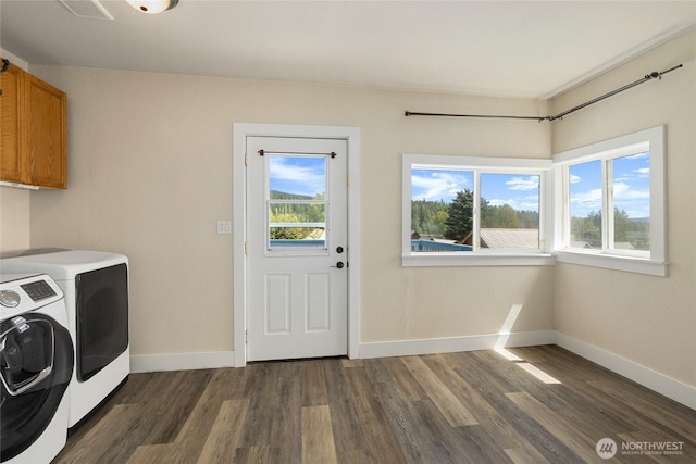 511 S 2nd St, Roslyn, WA 98941 - laundry area featuring cabinet space, washer and clothes dryer, plenty of natural light, and dark wood finished floors