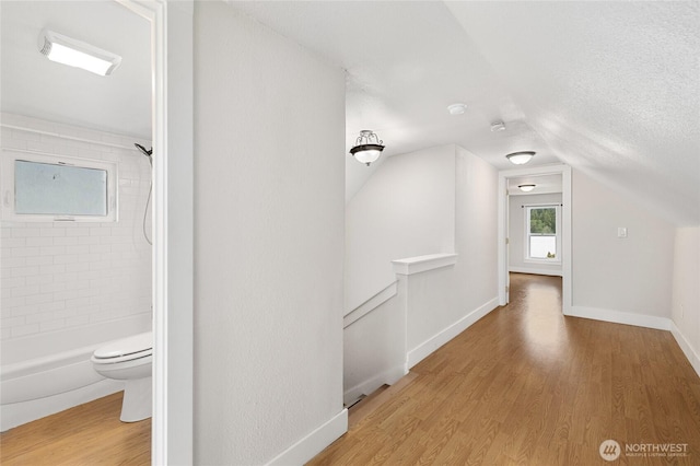 511 S 2nd St, Roslyn, WA 98941 - corridor featuring wood finished floors, vaulted ceiling, baseboards, and an upstairs landing