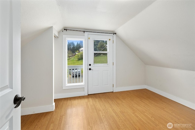 511 S 2nd St, Roslyn, WA 98941 - additional living space with vaulted ceiling, baseboards, and light wood-style flooring