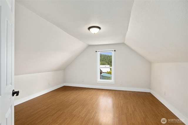 511 S 2nd St, Roslyn, WA 98941 - bonus room featuring wood finished floors, vaulted ceiling, and baseboards