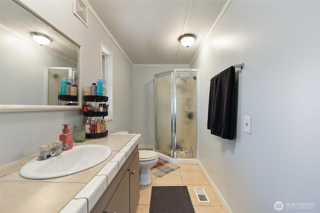 208 S Monroe St, Aberdeen, WA 98520 - bathroom with tile patterned floors, crown molding, a shower stall, vanity, and toilet