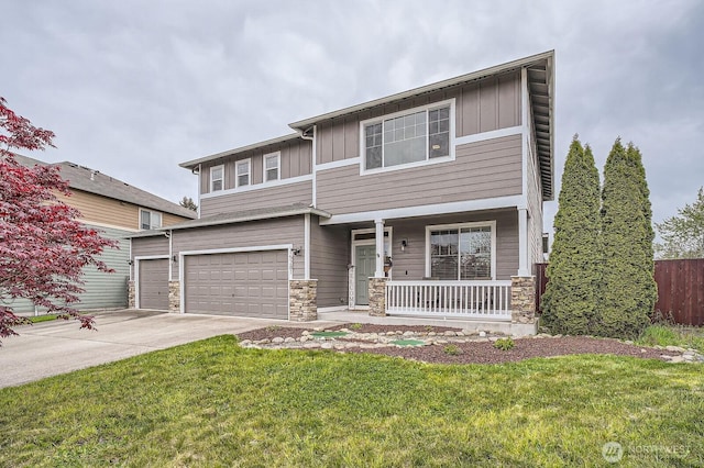15281 Kayla St SE, Yelm, WA 98597 - view of front facade featuring board and batten siding, a porch, driveway, and stone siding