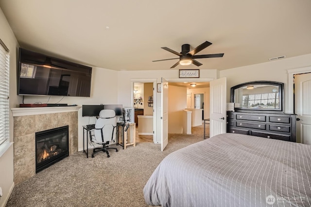 15281 Kayla St SE, Yelm, WA 98597 - bedroom featuring carpet flooring, a tiled fireplace, baseboards, and ceiling fan