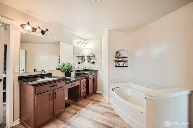15281 Kayla St SE, Yelm, WA 98597 - full bathroom with two vanities, wood finished floors, and a garden tub